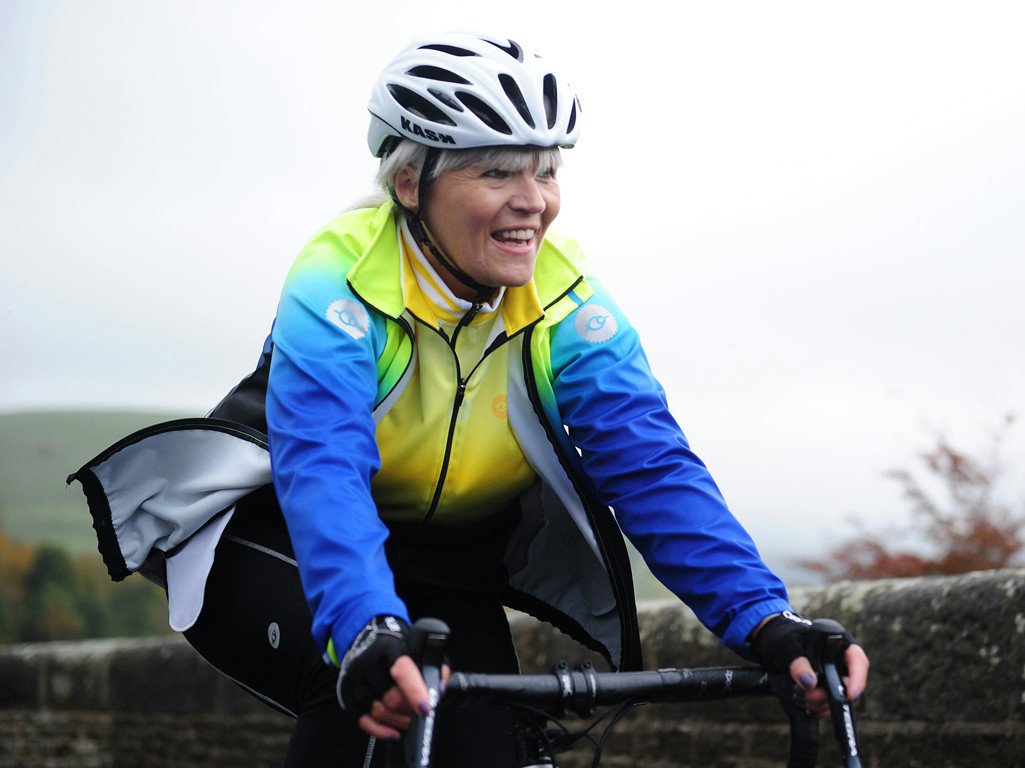 woman with helmet riding bicycle