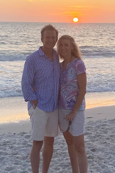 Michael Komara and his wife on a beach