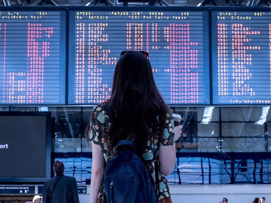 Woman checking flight board