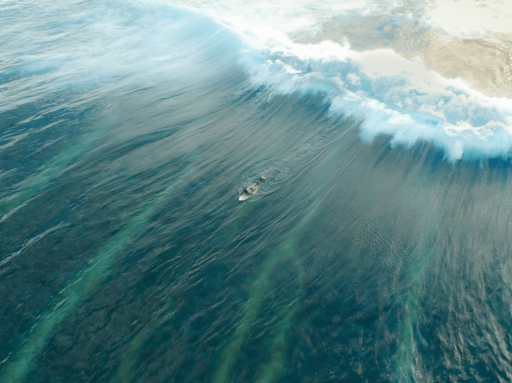 Surfer paddling out to waves